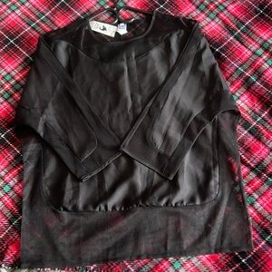 A black three quarter long sleeve women’s blouse with silk and sheer design.